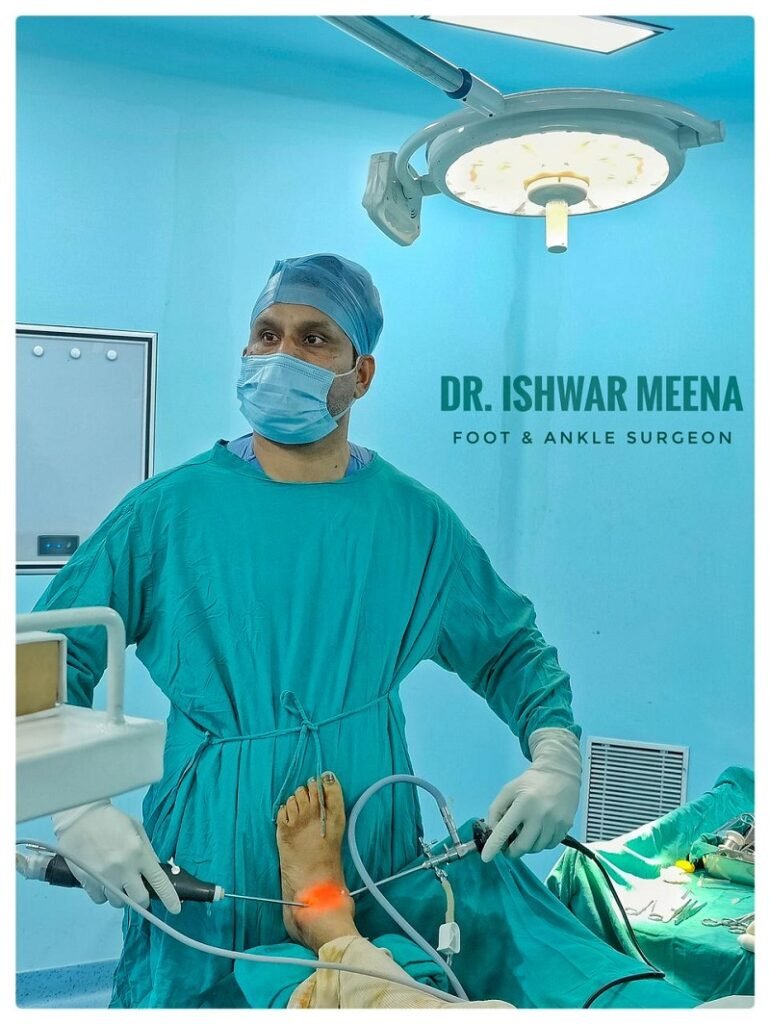 Dr. Ishwar Meena, a foot and ankle surgeon, performing surgery on a patient's foot in a brightly lit operating room.